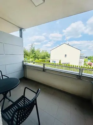 a balcony with a chair and a table and a window at Villa many separate rooms with Free Parking Praha 4 libuš in Prague