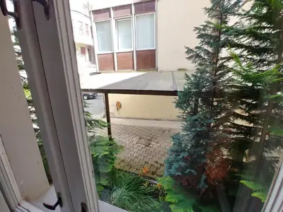 an open window with a christmas tree in a courtyard at Private Room With Free Parking Next to Railway Station in Prague