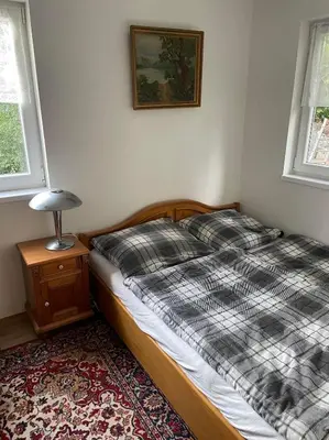 a bedroom with a bed and a lamp on a table at Chata Družec in Družec