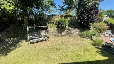 a garden with a gate in the grass at Chata Družec in Družec