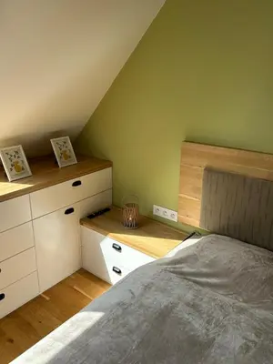 a bedroom with a bed and some wooden cabinets at Pistachio Apartment National Museum View in Prague