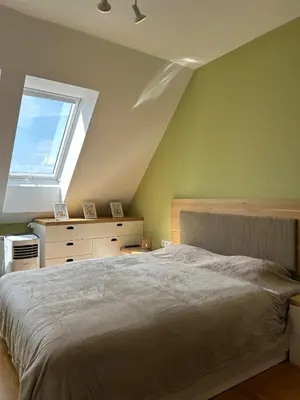 a bedroom with a large bed and a window at Pistachio Apartment National Museum View in Prague