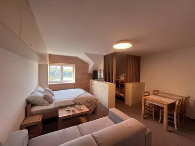 a living room with a couch and a bed at Župky in Županovice