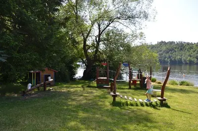 a park with a playground next to a lake at Župky in Županovice