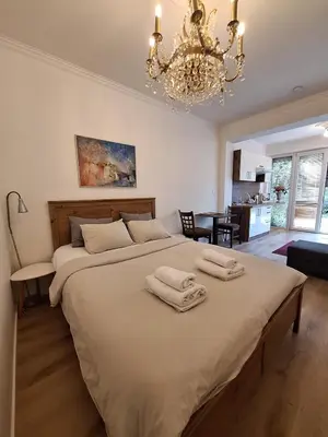 a bedroom with a large bed with two towels on it at Terrace Suite - KindStay Suites Prague Airport in Tuchoměřice