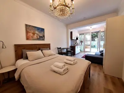 a bedroom with a large bed with towels on it at Terrace Suite - KindStay Suites Prague Airport in Tuchoměřice