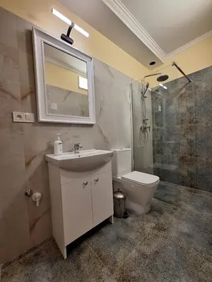 a bathroom with a sink and a toilet and a shower at Terrace Suite - KindStay Suites Prague Airport in Tuchoměřice