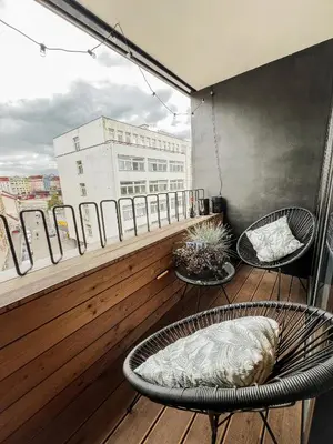 a balcony with two chairs and a table at The Urban Nest Metro Line in Prague