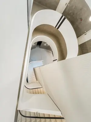 a spiral staircase in a building with a stair case at The Urban Nest Metro Line in Prague