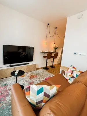 a living room with a couch and a flat screen tv at The Urban Nest Metro Line in Prague