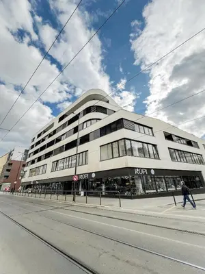 a man walking past a building on a street at The Urban Nest Metro Line in Prague