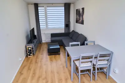 a living room with a table and a couch at Čenětická Apartment in Prague