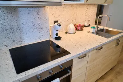 a kitchen with a sink and a counter top at Čenětická Apartment in Prague