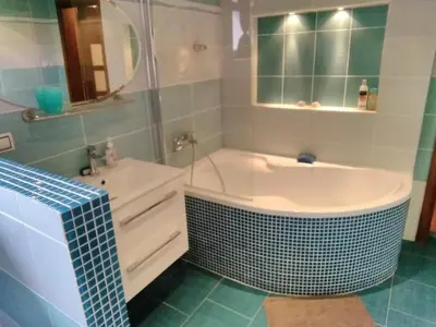 a bathroom with a tub and a sink at Sophia Cozy Self Catering Apartment in Dolní Břežany