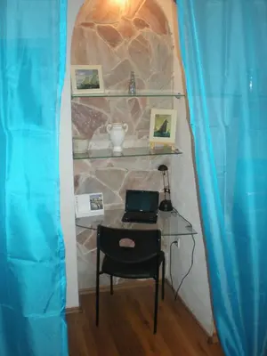 a desk with a laptop on a table in a room at Sophia Cozy Self Catering Apartment in Dolní Břežany