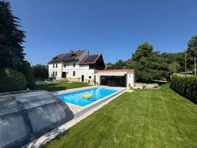 a house with a swimming pool in the yard at Luxusní chalupa Kokořínsko