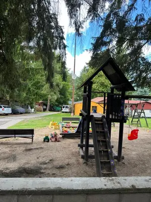 a playground with a slide and a bench at Solo tábořiště, kemp u vody, Nová Živohošť in Křečovice