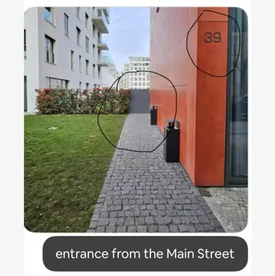 an entrance from the main street of a building at Bijou house in a private garden! in Prague
