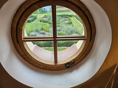 anorthole window with a view of a garden at Bijou house in a private garden! in Prague