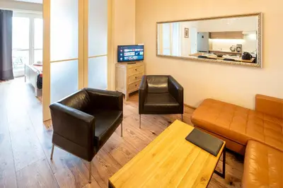 a bedroom with a bed and a large window at New Town - Apple Apartments in Prague