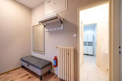 a room with a bench next to a radiator at New Town - Apple Apartments in Prague