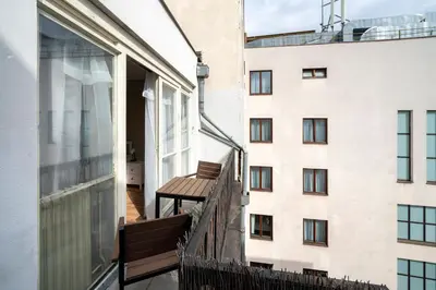 a bathroom with a tub sink and a washing machine at New Town - Apple Apartments in Prague