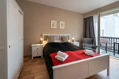 a bedroom with a desk with a chair and a mirror at New Town - Apple Apartments in Prague