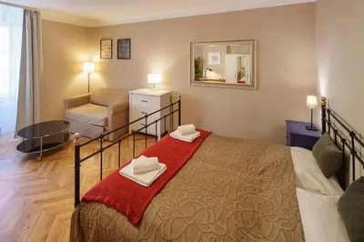a bedroom with a bed and a living room at Old Town - Templova Apartments in Prague