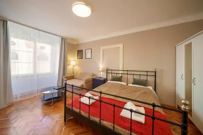 a bedroom with a bed and a dresser and a mirror at Old Town - Templova Apartments in Prague