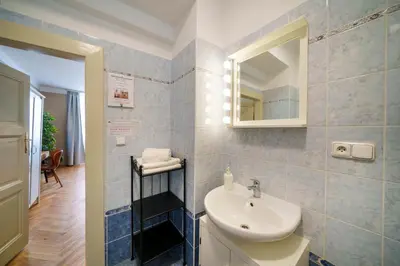 a bathroom with a sink and a mirror at Old Town - Templova Apartments in Prague