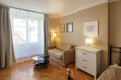 a bedroom with a bed and a desk and a chair at Old Town - Templova Apartments in Prague