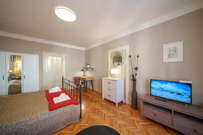 a bedroom with a bed and a flat screen tv at Old Town - Templova Apartments in Prague