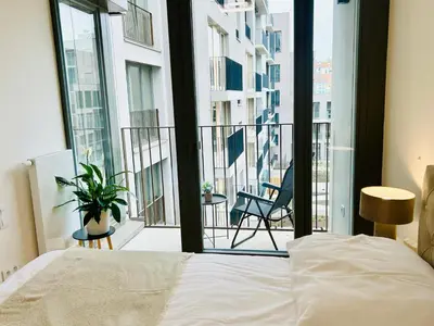 a bedroom with a bed and a view of a balcony at Luxury apartments with beautiful views in Prague