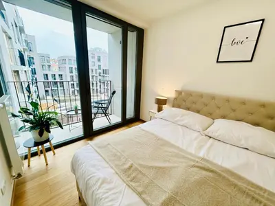 a bedroom with a bed and a large window at Luxury apartments with beautiful views in Prague