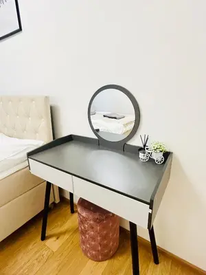 a mirror on a table next to a bed at Luxury apartments with beautiful views in Prague