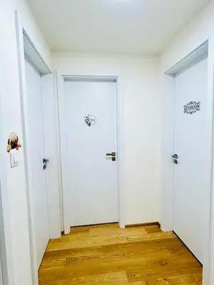 two white doors in a room with wood floors at Luxury apartments with beautiful views in Prague
