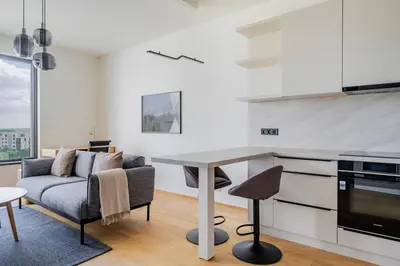 a kitchen and living room with a couch and a table at Blueground Prague 9 balcony free parking PRG-46 in Prague
