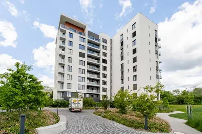 an apartment building with a bus in front of it at Blueground Prague 9 balcony free parking PRG-46 in Prague