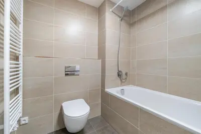 a bathroom with a toilet and a bath tub at Blueground Prague 9 balcony free parking PRG-46 in Prague