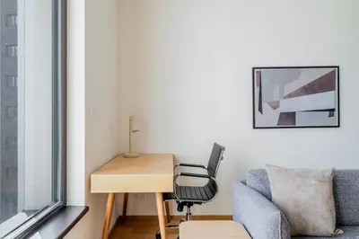 a room with a desk and a chair and a desk and a window at Blueground Prague 9 balcony free parking PRG-46 in Prague