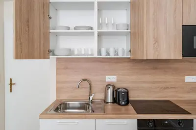 a kitchen with a sink and a counter top at Blueground Letná furnished studio foodie area PRG-49 in Prague
