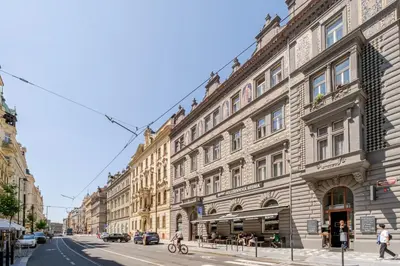 a large building on a city street with buildings at Blueground Letná furnished studio foodie area PRG-49 in Prague