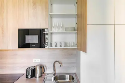 a kitchen with a sink and a microwave at Blueground Letná furnished studio foodie area PRG-54 in Prague
