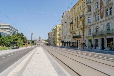 an empty street in a city with buildings at Blueground Letná furnished studio foodie area PRG-54 in Prague