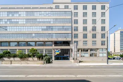 an office building with a street in front of it at Blueground Letná museums foodie area PRG-56 in Prague