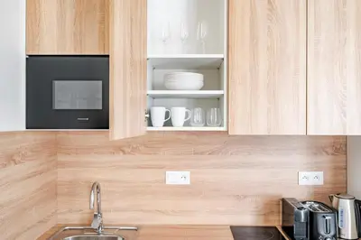 a kitchen with a sink and a microwave at Blueground Letná museums foodie area PRG-56 in Prague