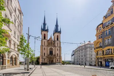 an old church with two towers on a city street at Blueground Letná museums foodie area PRG-56 in Prague