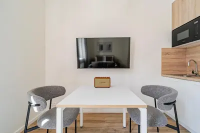 a kitchen with a white table and chairs at Blueground Letná museums foodie area PRG-56 in Prague