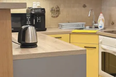 a kitchen with a coffee maker on a counter at Spacious place on Metro station Andel in Prague