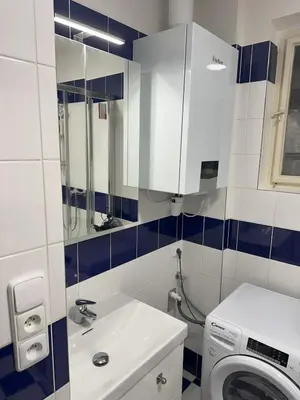 a bathroom with a washing machine and a sink at Spacious place on Metro station Andel in Prague